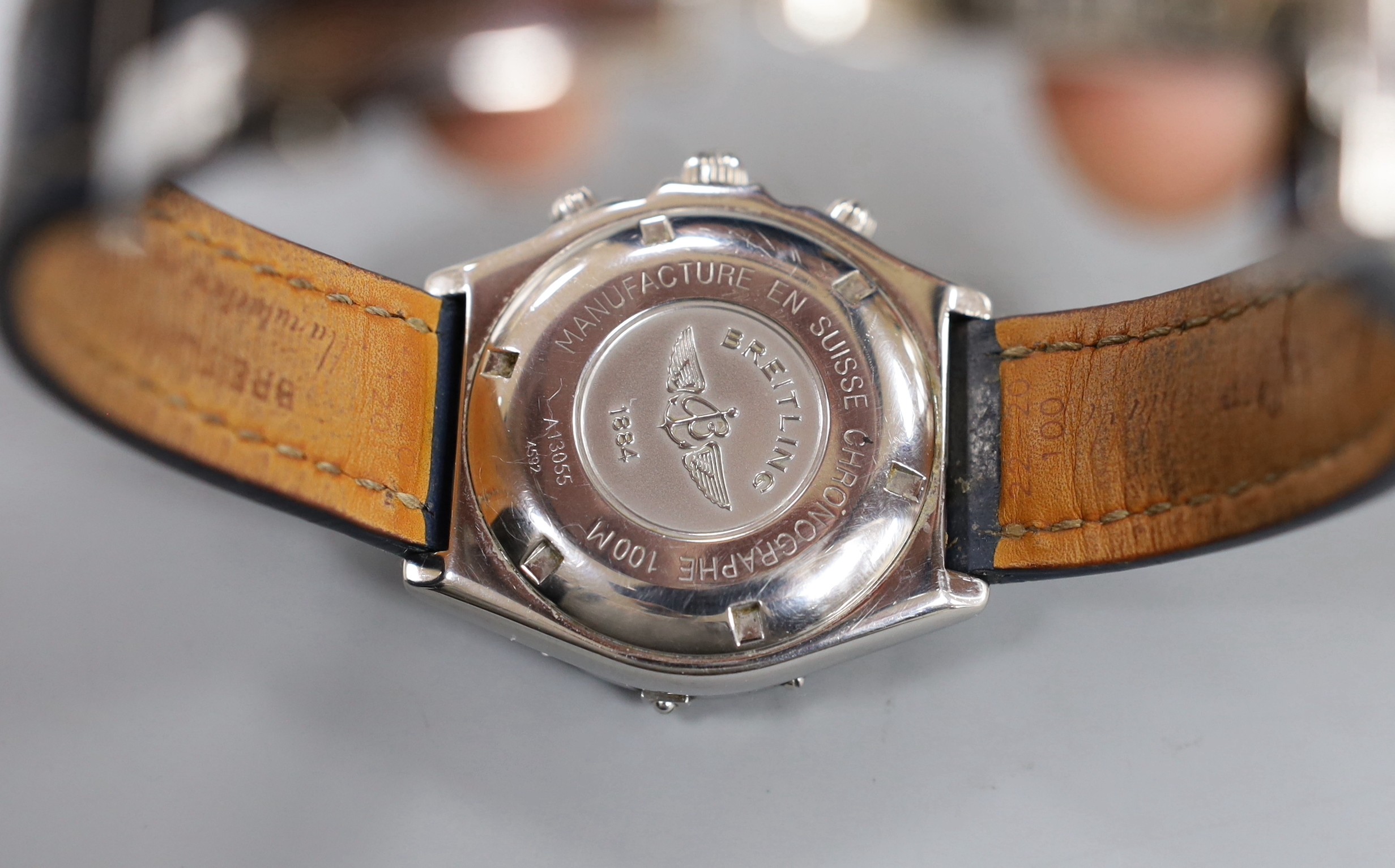 A gentleman's modern stainless steel Breitling chronograph automatic wrist watch, with blue Roman dial, on leather strap with deployment clasp, no box or papers.